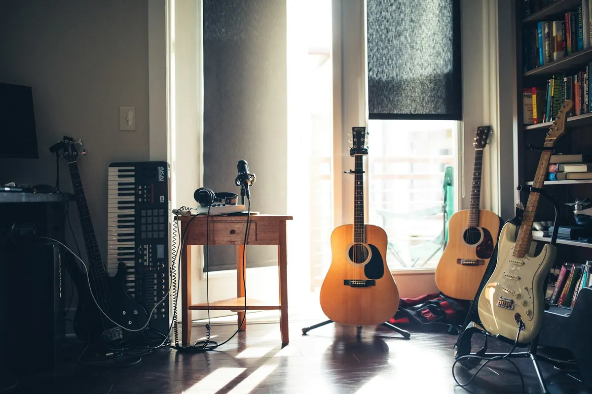 A practice room with guitars, keyboard, and other instruments