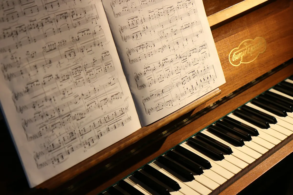 A young student learning piano with a teacher